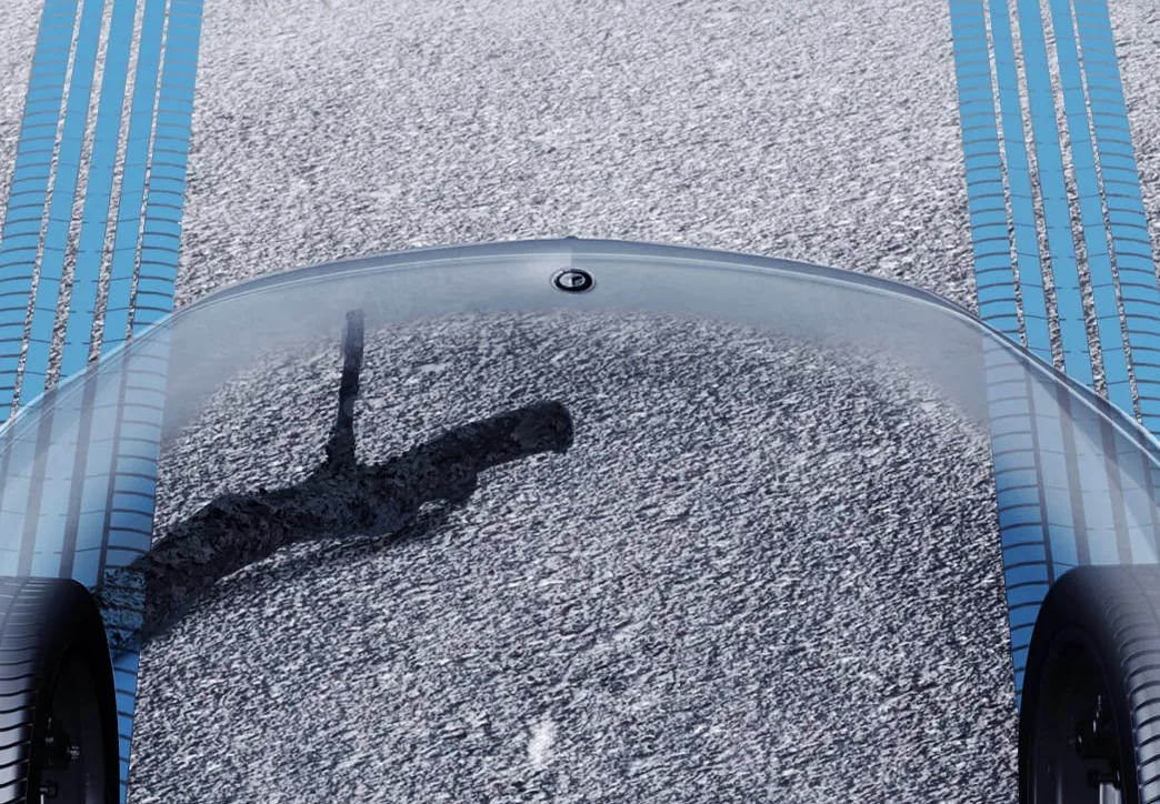 Transparent Hood view showing gravel terrain beneath the front of the vehicle