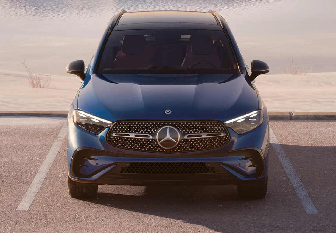 Front view of a blue GLC with AMG Line styling parked in a desert lot