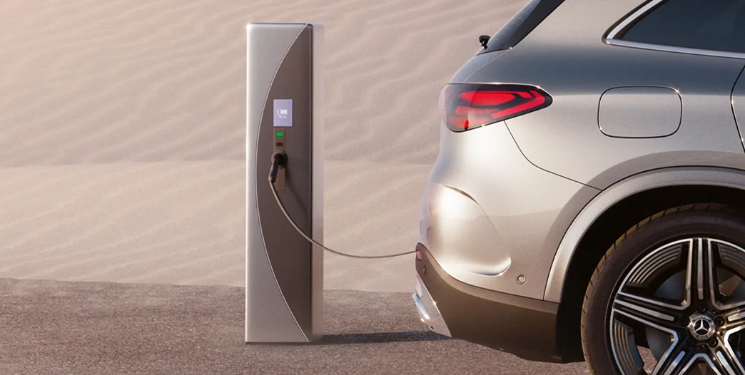Silver GLC 350e plugged into a charging station in the desert