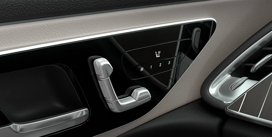 Seat-shaped power seat and memory controls on an E-Class door panel