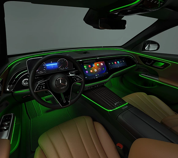 E-Class cabin lit with green ambient lighting