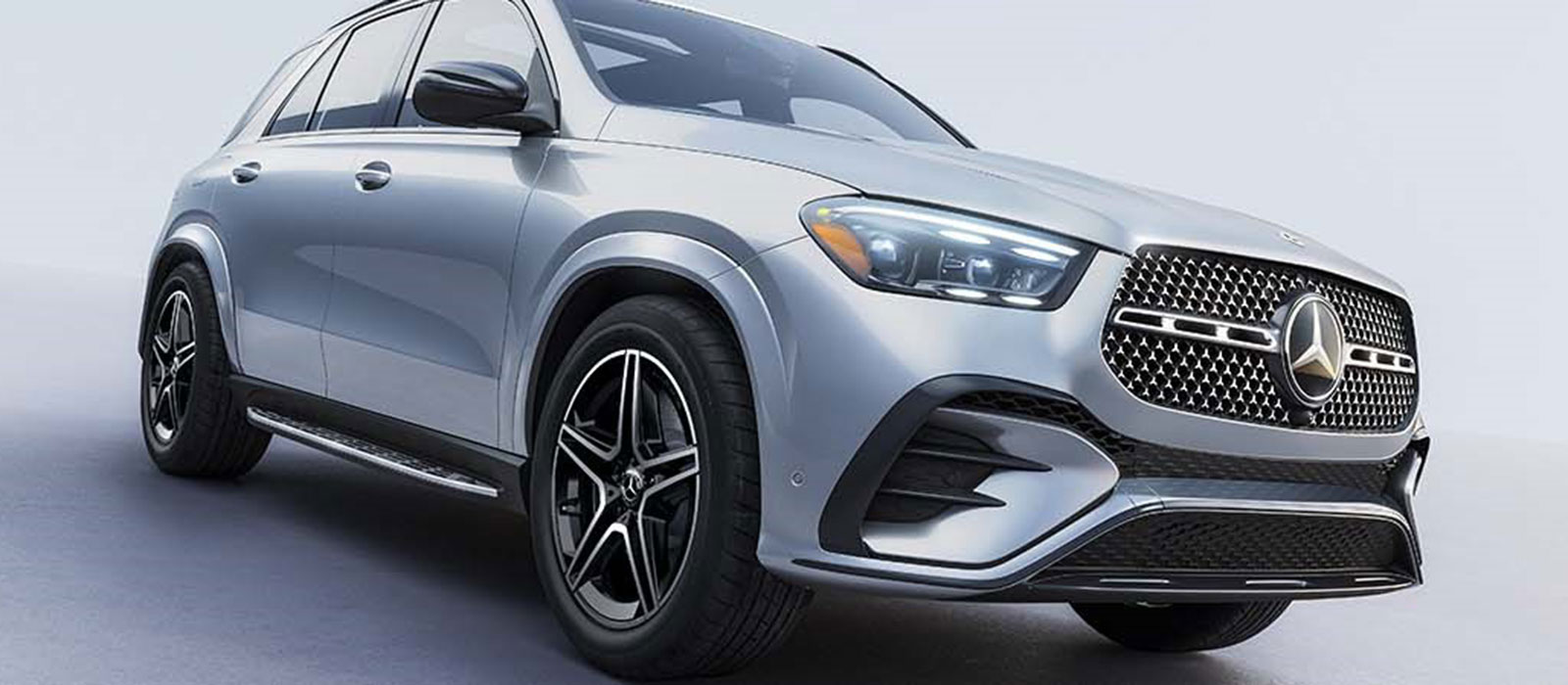 2025 Mercedes-Benz GLE 450 Trim Comparison Mercedes-Benz GLE parked in a silver showroom