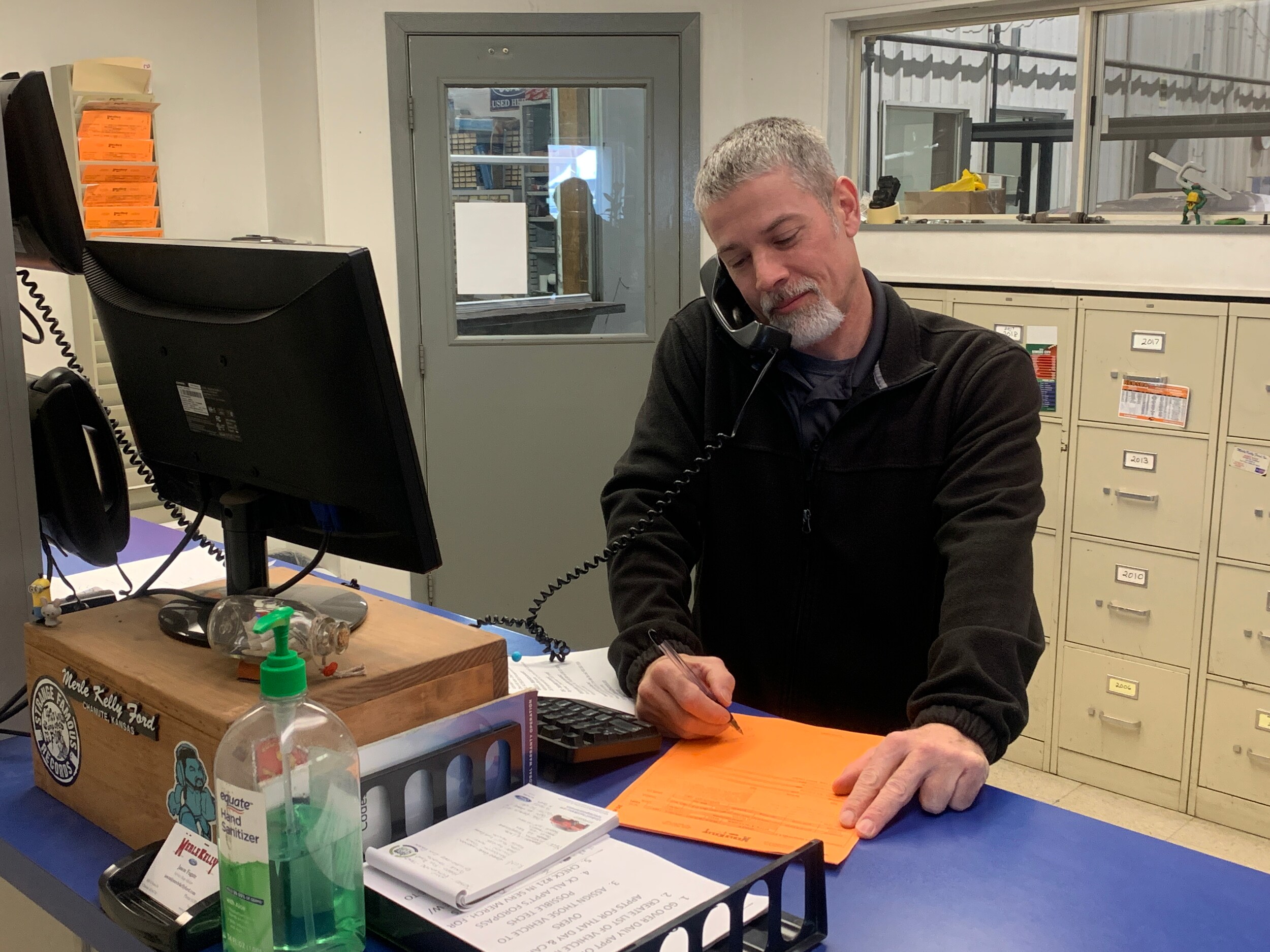 Service Advisor Jason Fugate assists a customer over the phone