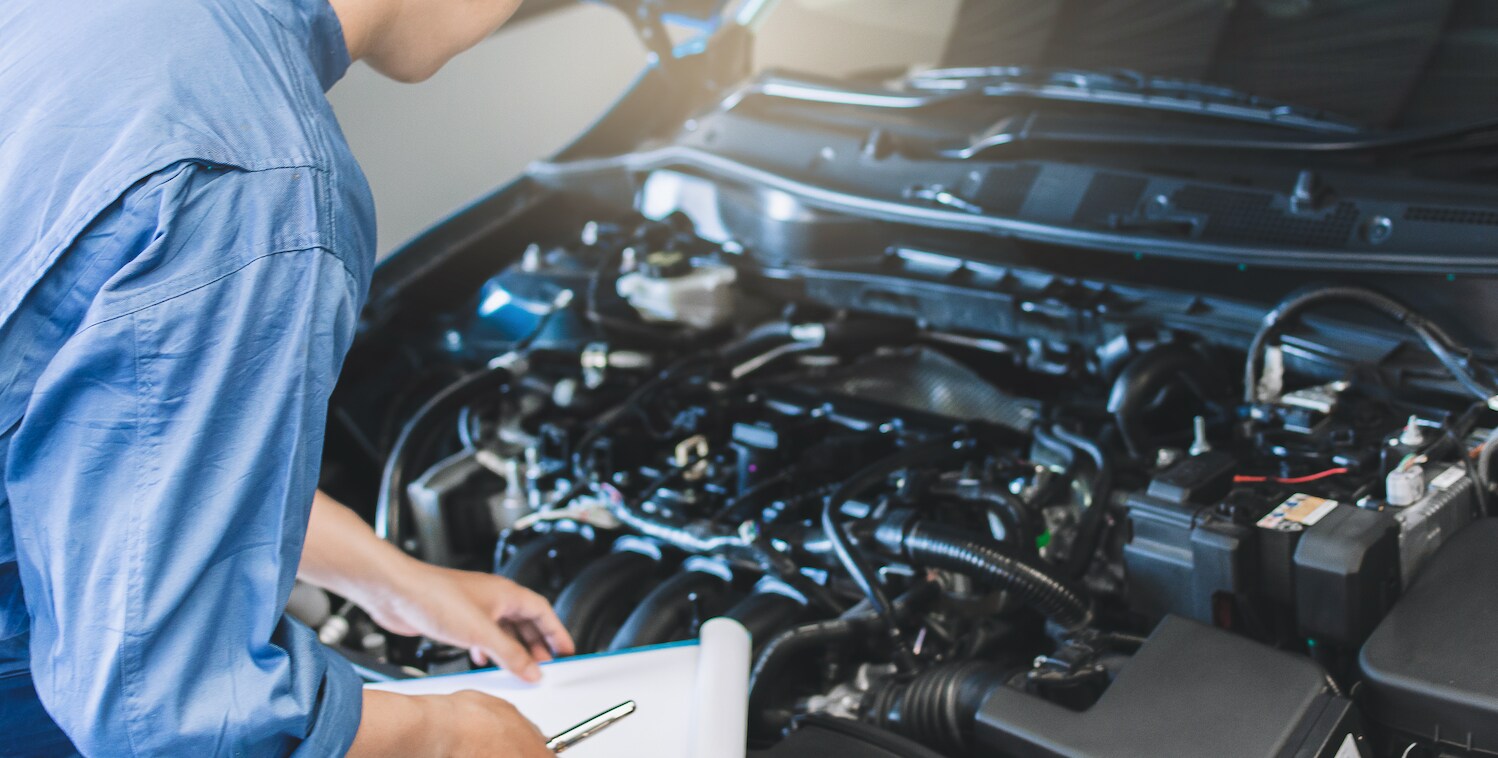 Certified technician repairing a car's transmission.
