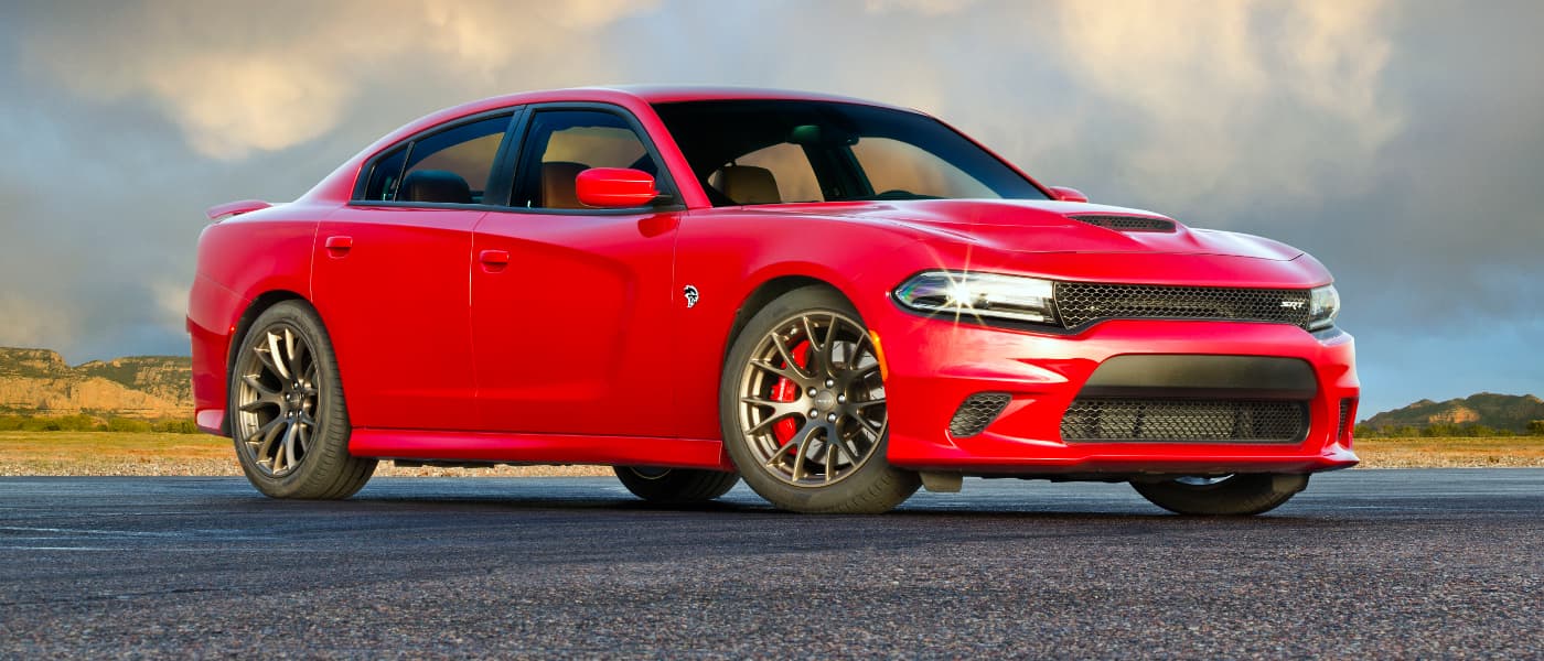 Dodge Charger A red Dodge Charger parked in front of a desert landscape