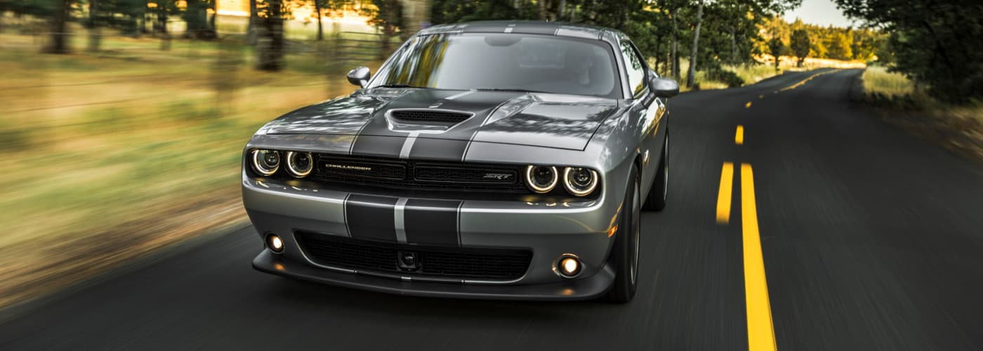 2019 Dodge Challenger A silver 2019 Dodge Challenger driving down an open country road