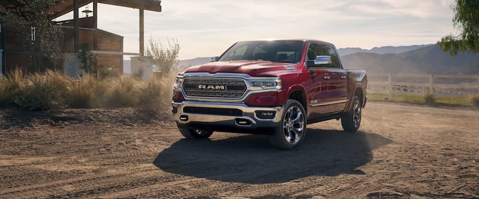 2019 Ram 1500 A red 2019 Ram 1500 driving on a dirt road near the mountains