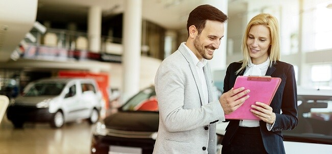Midway Dodge Financing A man and woman talking about financing a new Dodge car in Chicago, IL