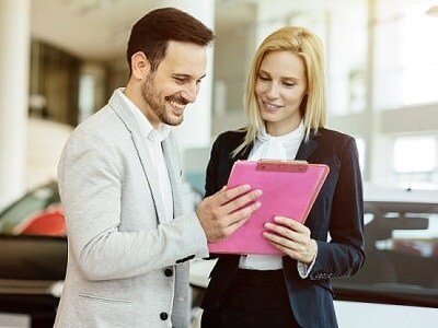Dodge Finance A dodge finance expert going over costs with a client
