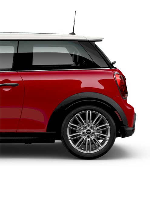 Side view of the rear of a red MINI Cooper 2 Door parked on a blank white surface with its shadow underneath it
and nothing in the background.