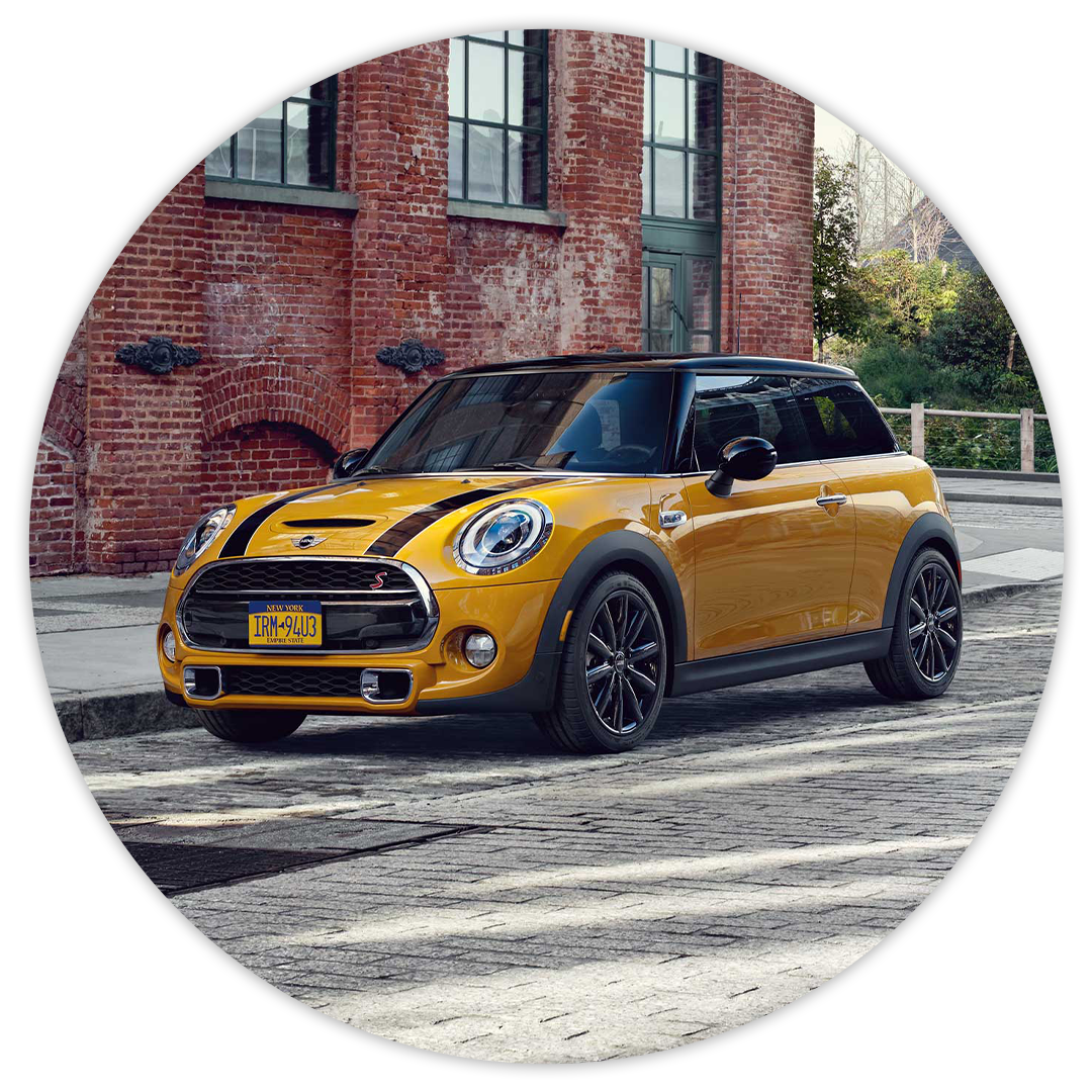Fast, Simple, Fair Pricing at MINI of Baltimore County | Yellow 2020 MINI Cooper S Hardtop Two Door Driving Through City