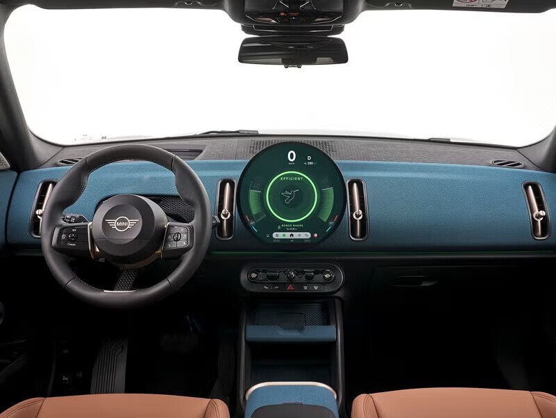 The MINI Countryman SE ALL4's 9.4-inch circular OLED display with wireless Apple CarPlay, Android Auto integration, Spotify, and cloud-based navigation.