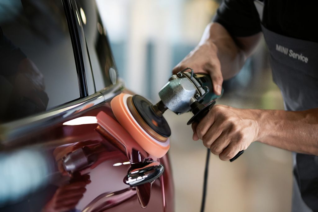 MINI Certified Technicians Car buffer buffing out scratches.