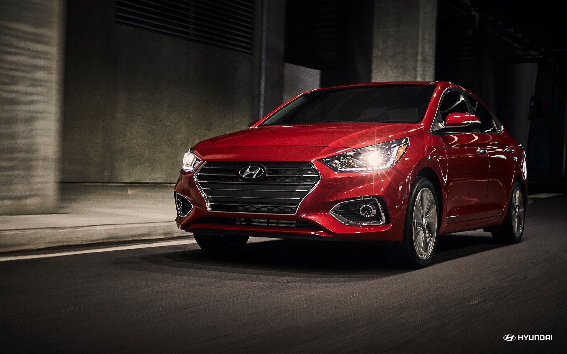 2018 Hyundai Accent red Hyundai Accent sedan driving by cement stantions