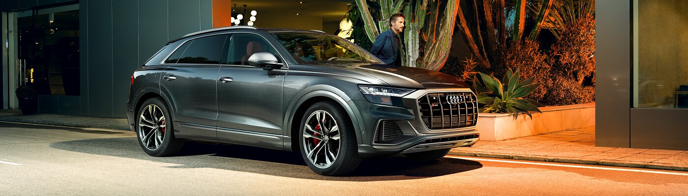 Audi SQ8 Audi SQ8 Prestige parked in front of a modern house