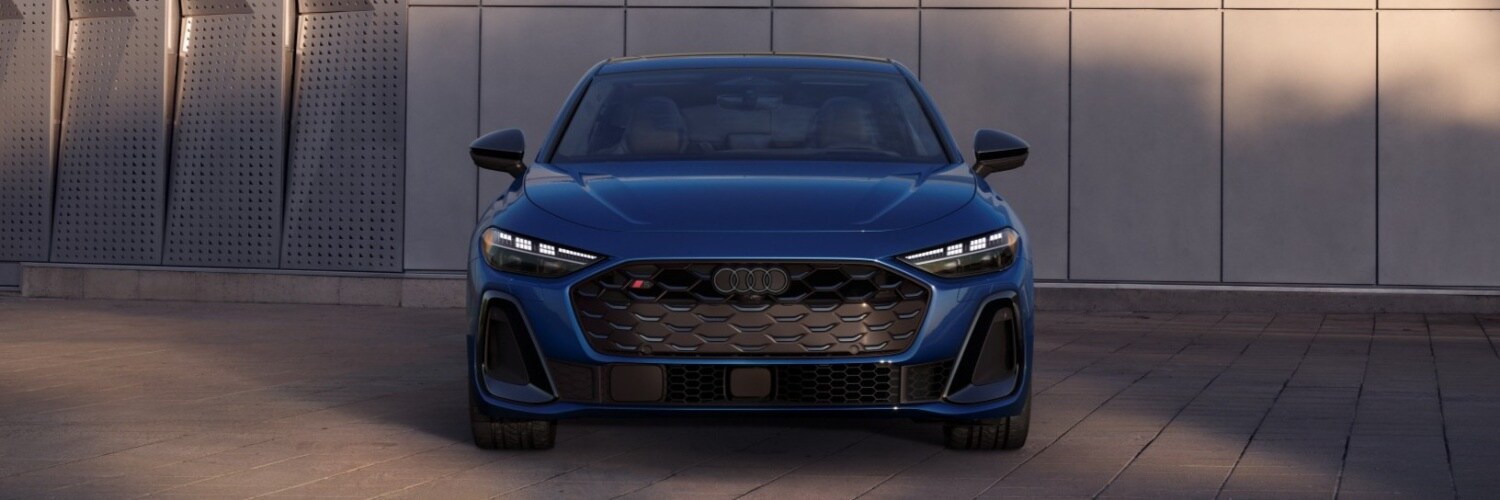 Audi S5 Sedan Dark Blue Audi S5 Sedan parked in front of a concrete wall