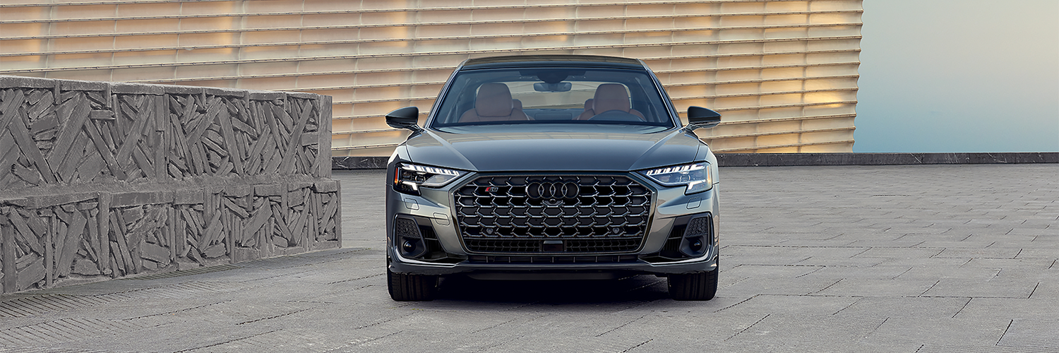 Audi S8 Audi S8 parked next to a modern stone wall