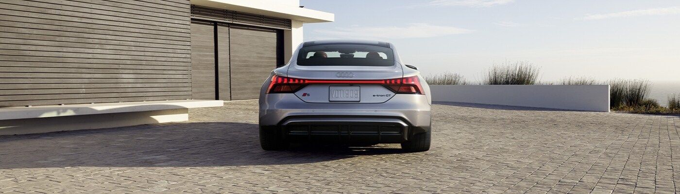 Audi S e-tron GT Silver Audi S e-tron GT parked by a home that overlooks a shoreline