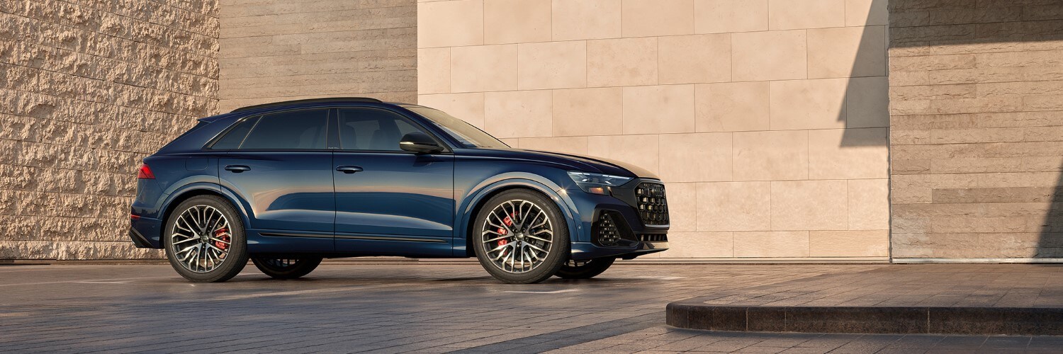 Audi SQ8 Audi SQ8 Premium Plus parked in front of a modern house