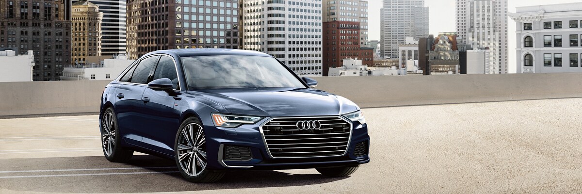 Audi A6 Audi A6 parked on top of a garage in a city