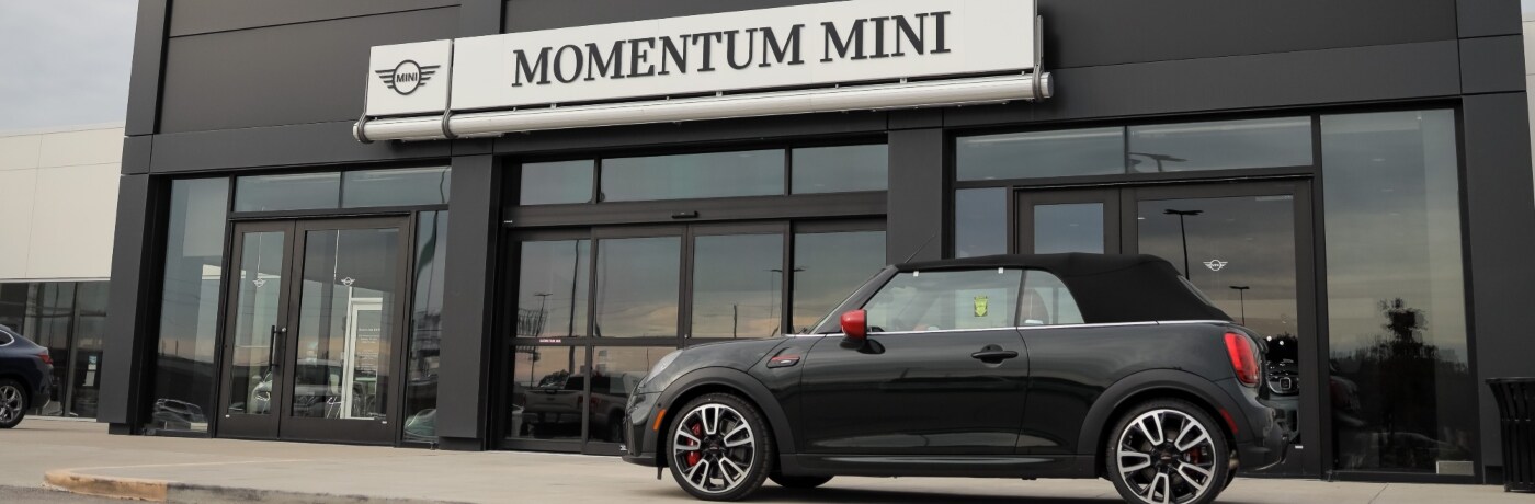 Momentum MINI Momentum MINI Dealership exterior with a MINI hatchback parked in front