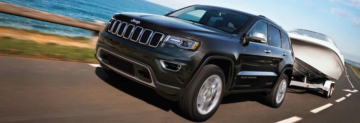 Black Jeep Grand Cherokee Towing a Boat