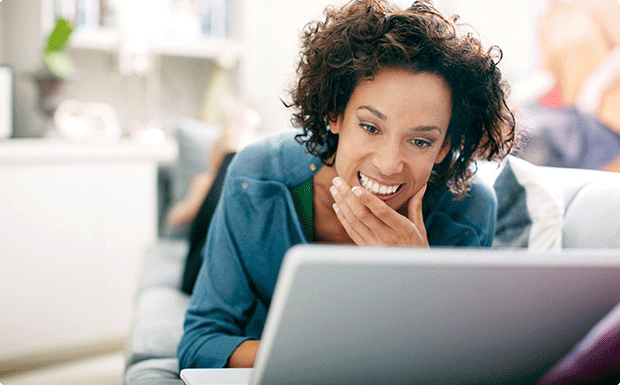Smiling woman looking at computer. Smiling woman looking at computer.