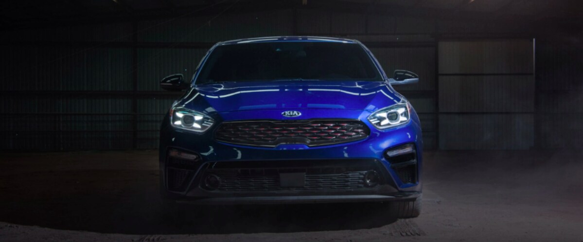 Blue Kia Forte parked