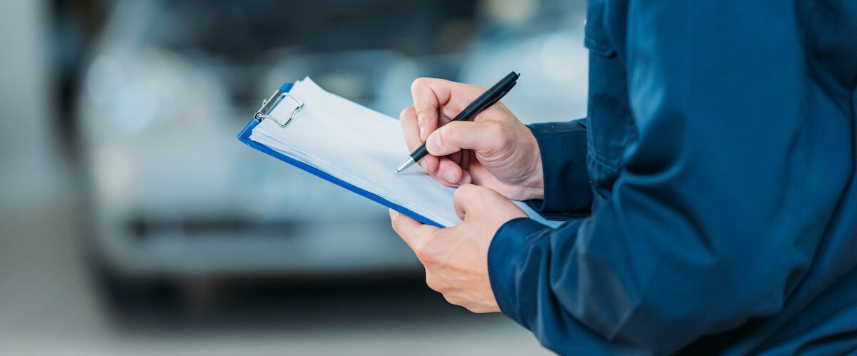 Mechanic writing on clipboard