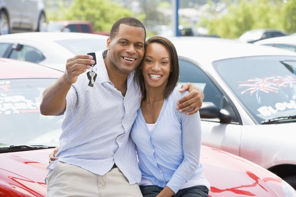 Couple holding up car keys of new car.jpg