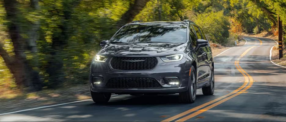 Chrysler Pacifica Kissimmee, FL head on shot of Chrysler Pacifica driving down an empty road