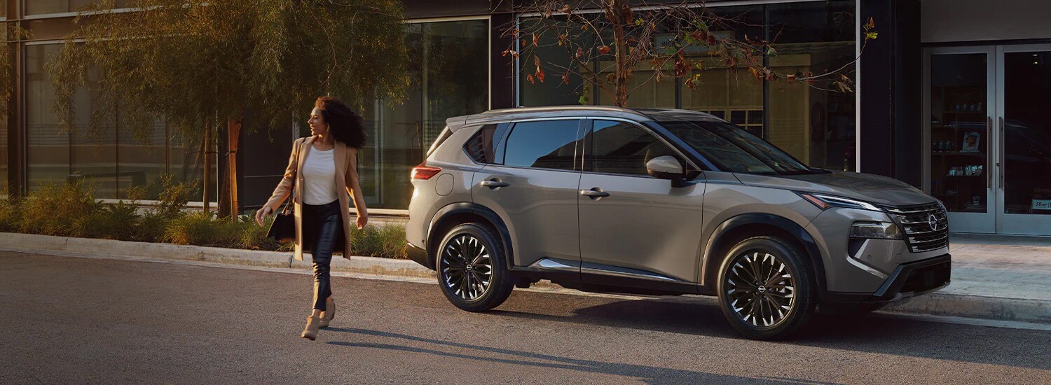Lady walking away from her parked Nissan SUV