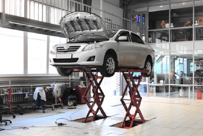 car-on-jacks-in-service-center