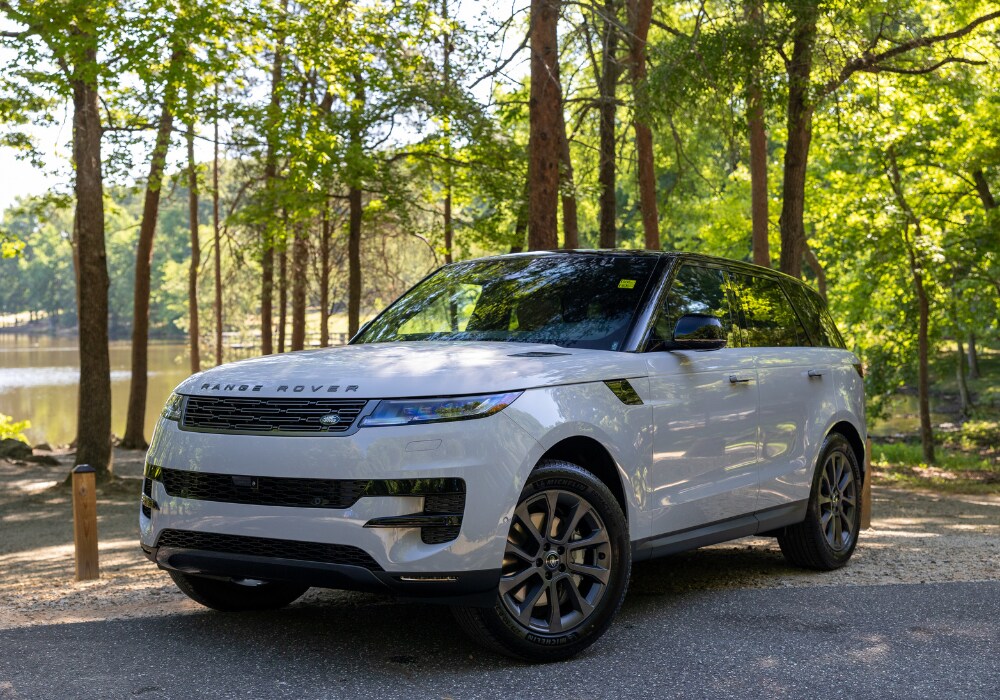 land-range-rover-cars-for-sale-greensboro.png White Range Rover for sale parked outside with trees in the background