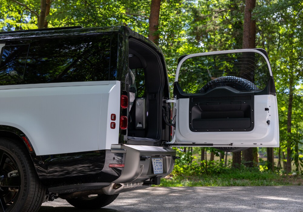 defender-130-dimensions.png The back half of the 2025 Defender 130. The trunk door is open, and the third row of seat is visible.