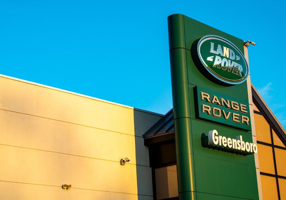 land-rover-defender-models.png Land Rover logo displayed on the exterior of the Land Rover Greensboro dealership
