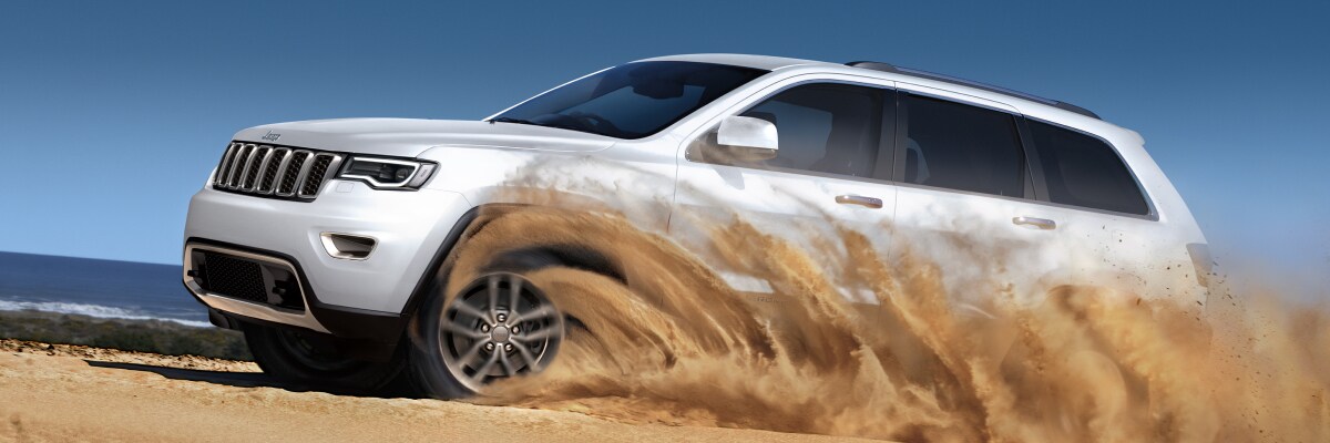 2019-Jeep-GrandCherokee-Limited-SUV-L01 (1).jpg New Jeep Grand Cherokee driving through the dirt
