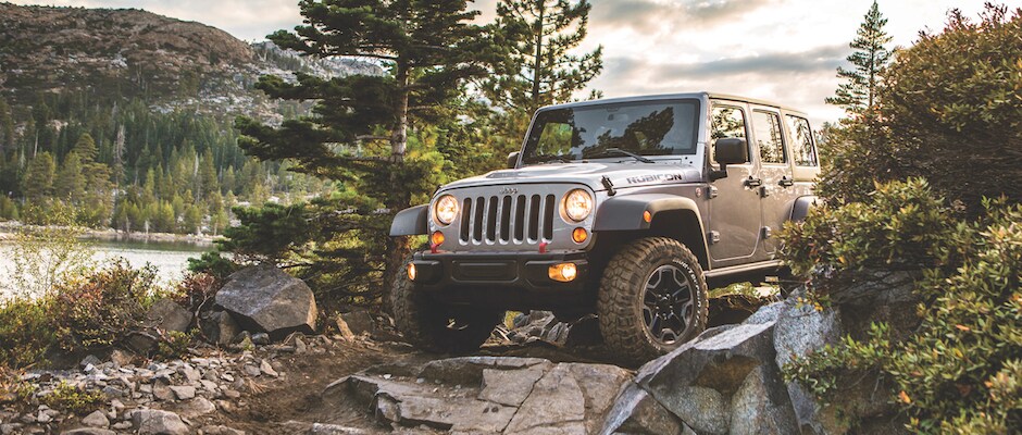 Jeep Wrangler going off roading A 2013 Jeep Wrangler going offroading by a lake and mountains