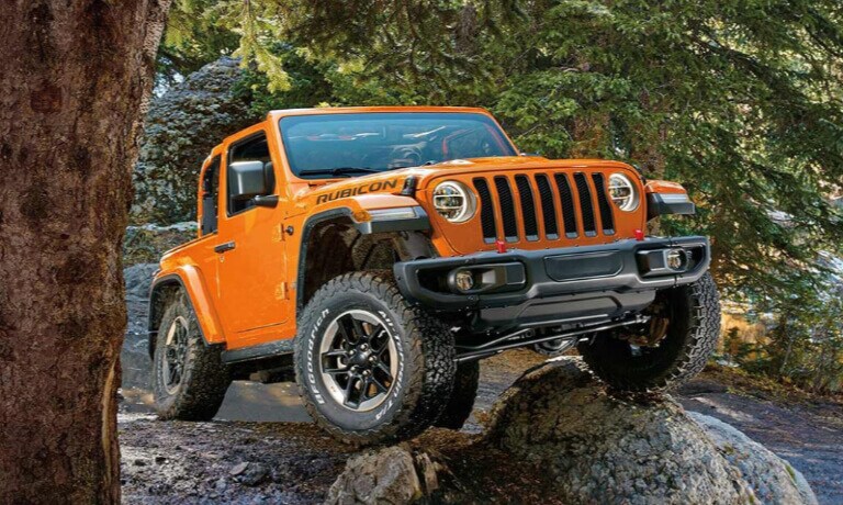 Jeep Wrangler in orange driving off road