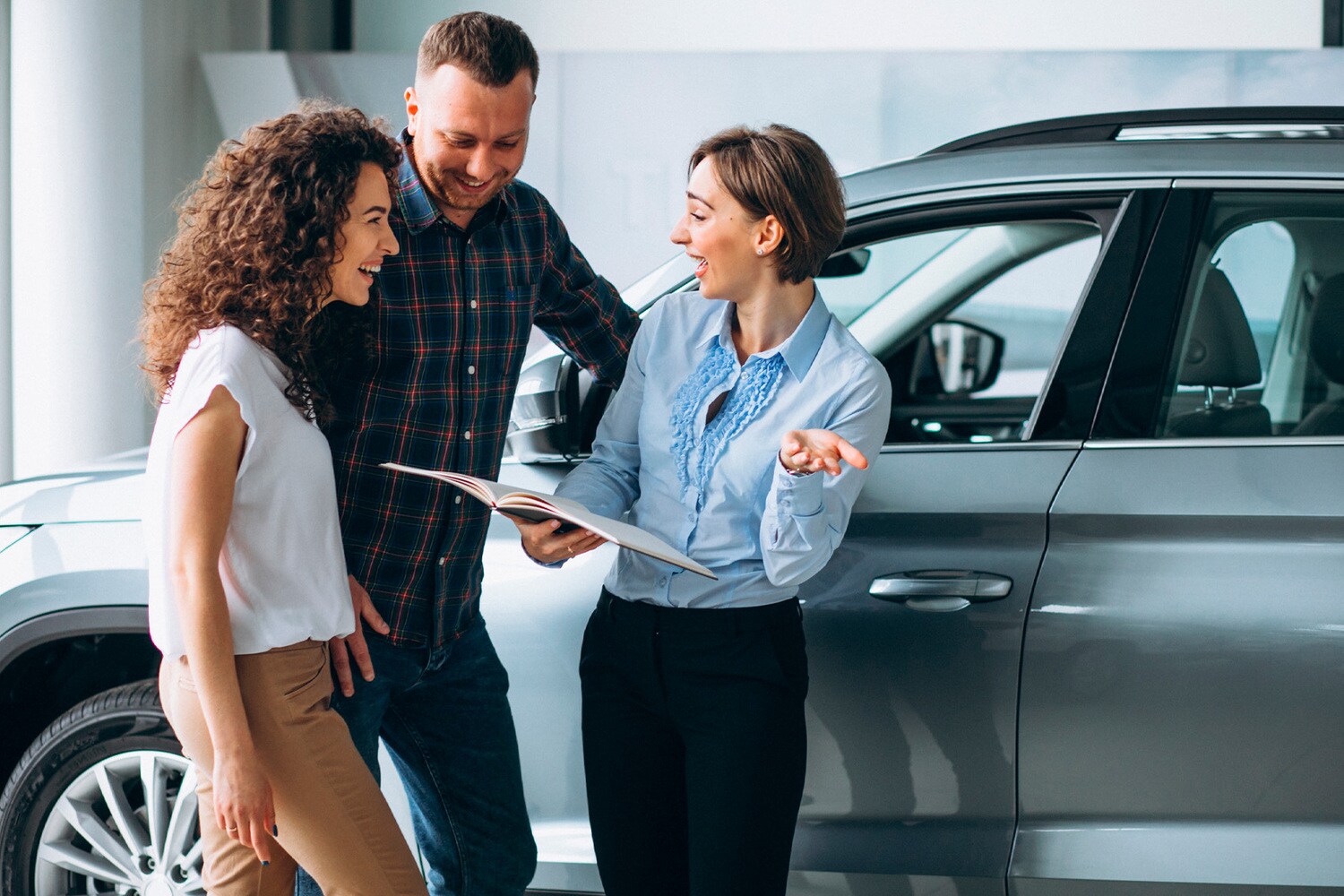 Finance Center team memeber discussing financing options with couple at New Brighton Ford