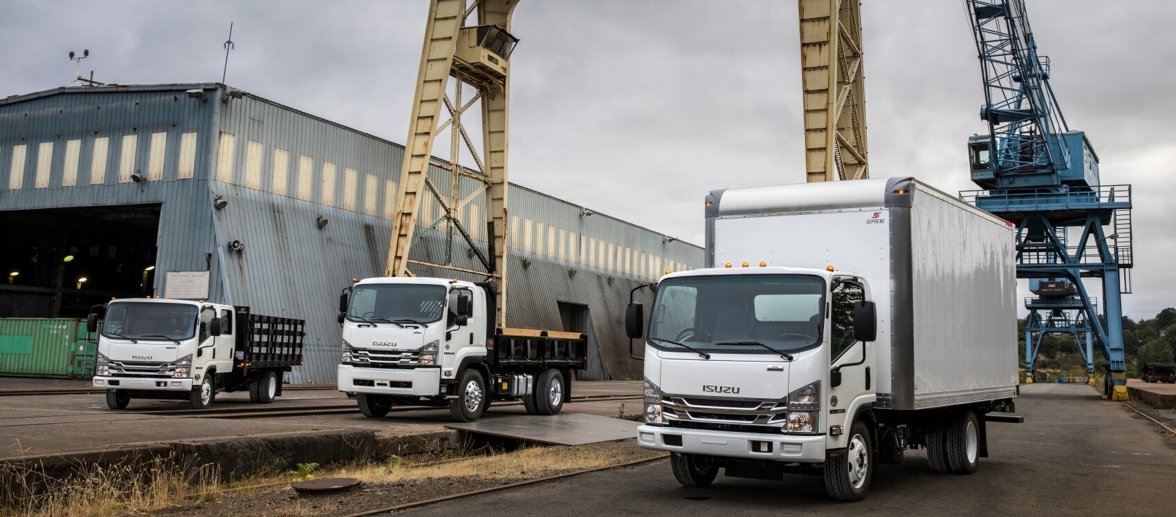 Isuzu commercial truck lineup parked on worksite.jpg