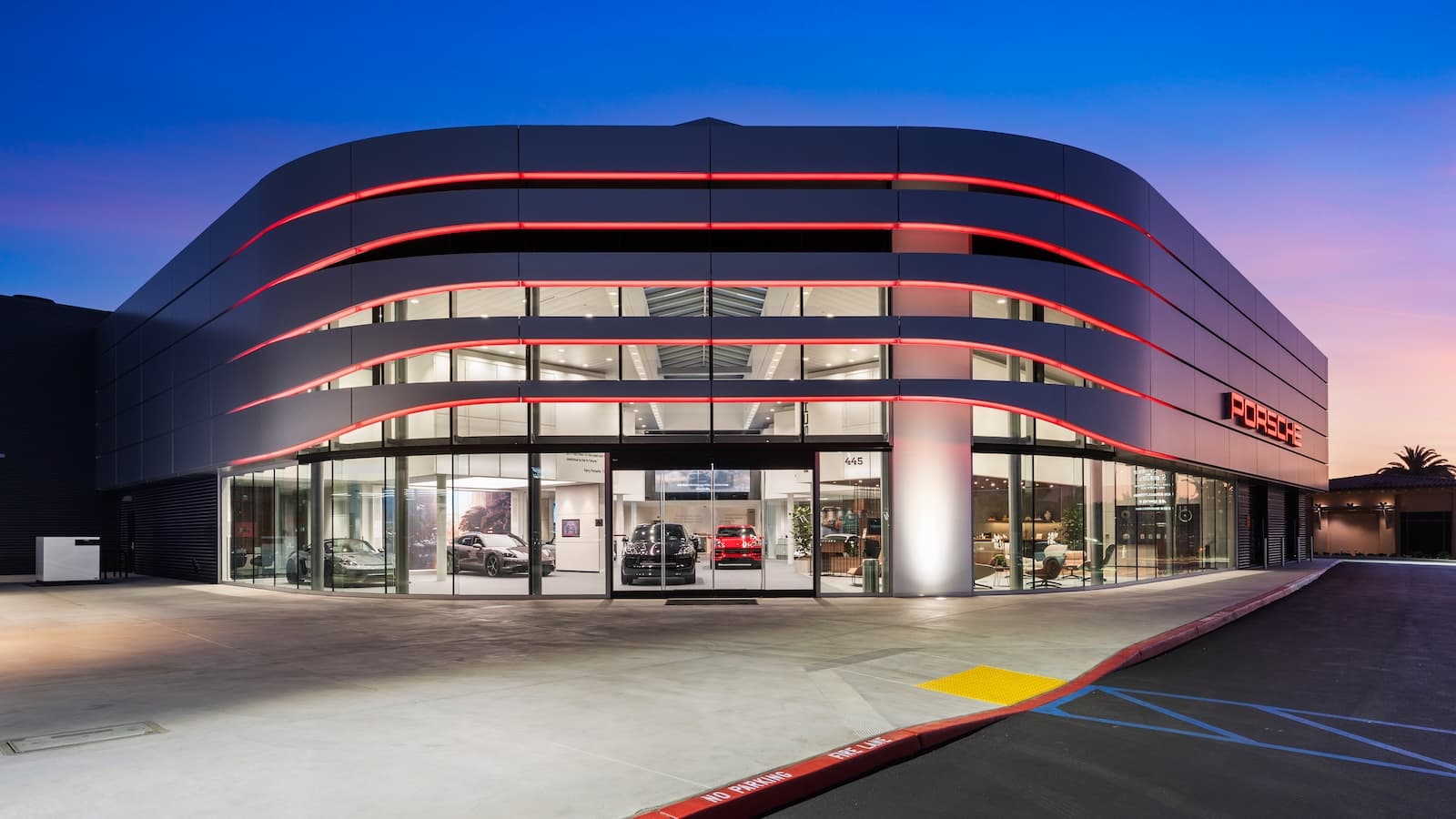 View of the Porsche Newport Beach front entrance in the evening