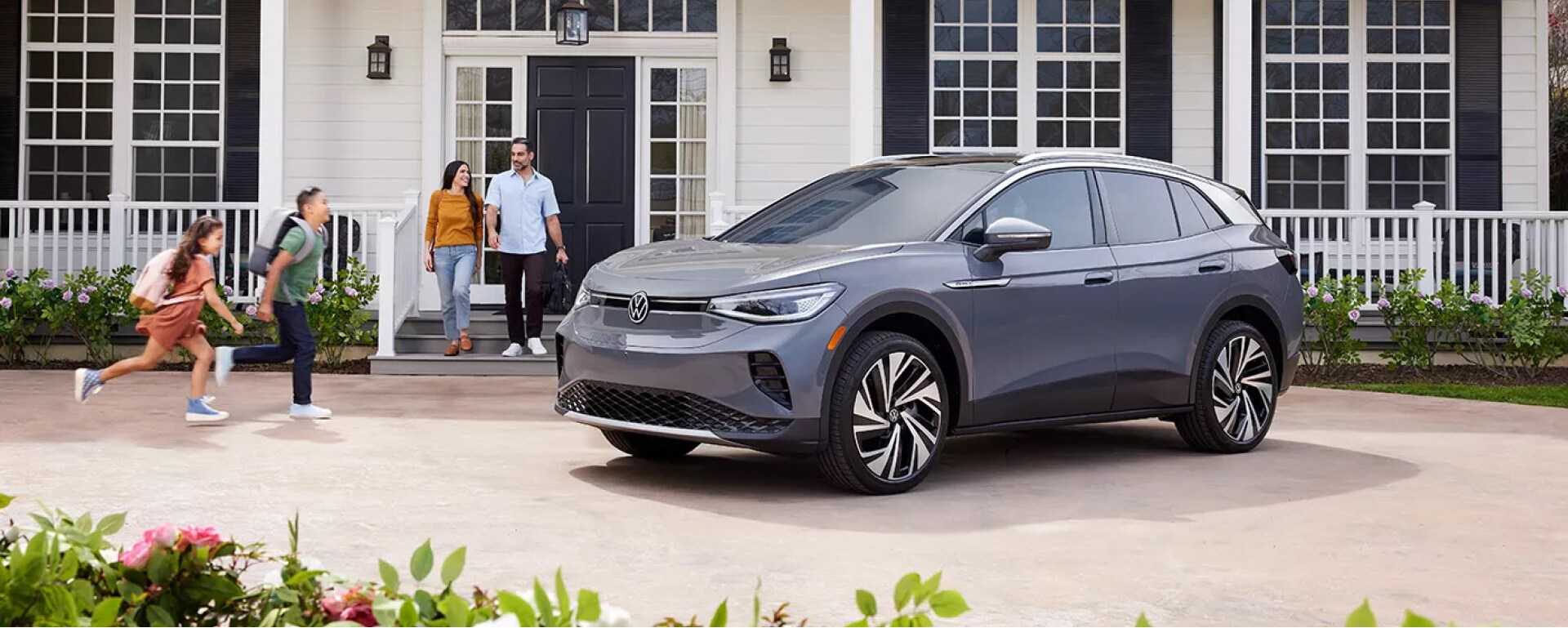 Family entering a Gray Volkswagen SUV