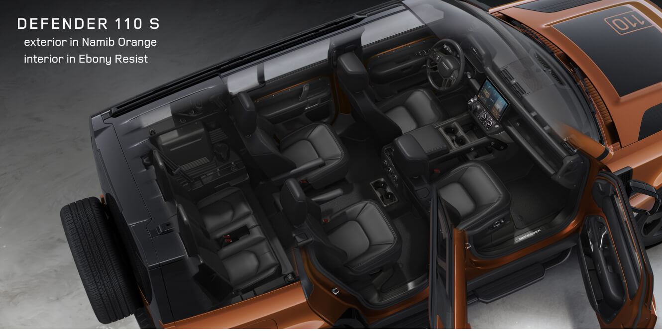 High-angle overhead view of a Land Rover Defender 110 S in Namib Orange showing its premium 6-seat layout with Ebony Resist.