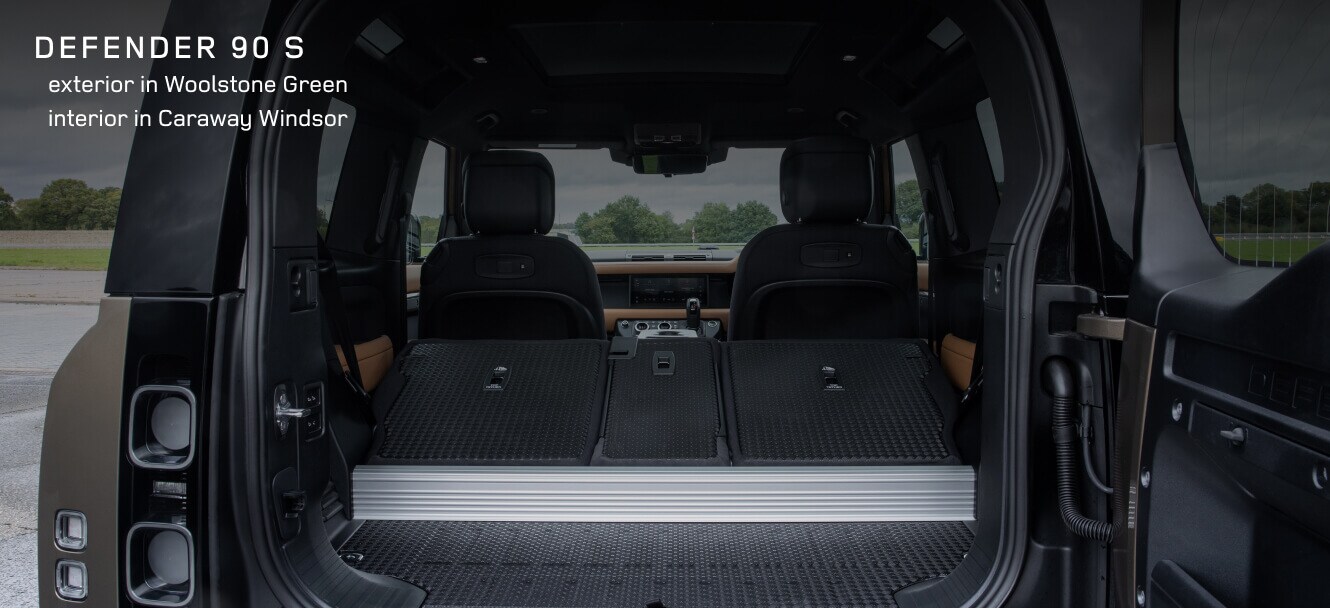 Rear cargo area view of a Land Rover Defender 90 S in showing Caraway Windsor interior.