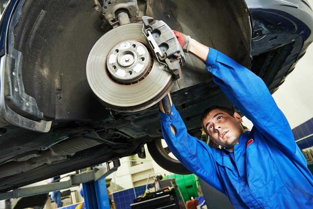Mechanic conducting brake repair