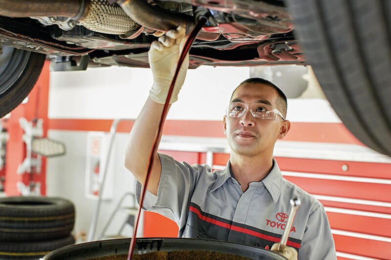 Toyota Service Technician fixing a car