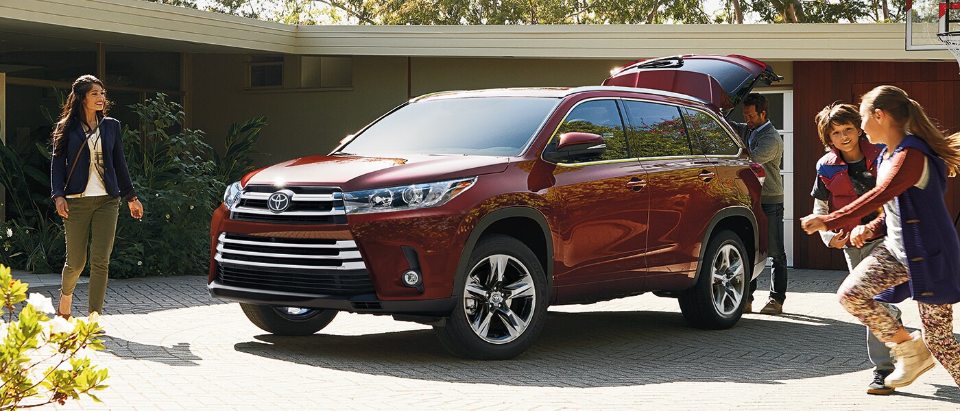 2019 Toyota RAV4 parked in a driveway with kids playing nearby