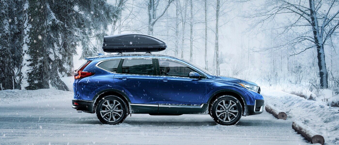 2020 Honda CR-V in blue parked in a parkinglot in the forest