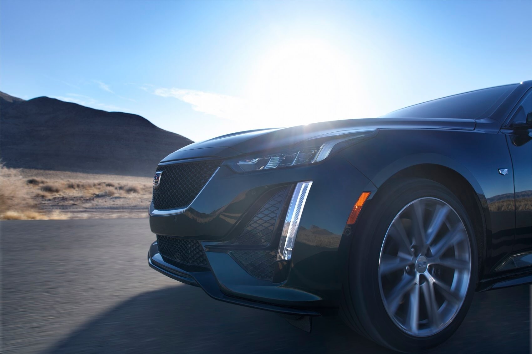 Close up side front view of used Cadillac vehicle driving
